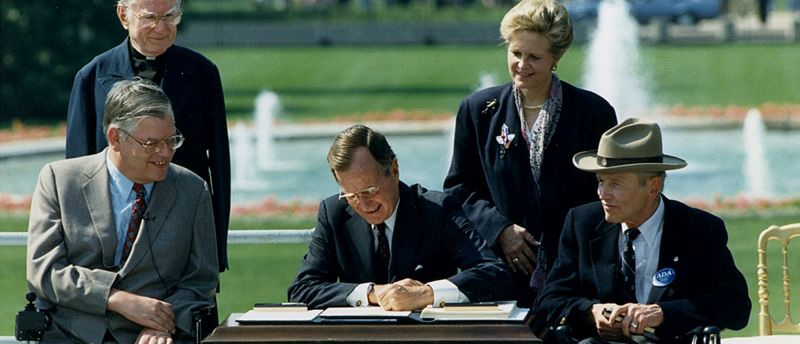George H. Bush signing into law the Americans with Disabilities Act (ADA) on July 26, 1990.